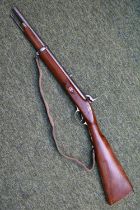 19thC Indian Carbine on walnut stock with brass and steel fittings and fabric strap. 84cm in