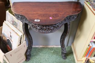 Heavily Carved Anglo Indian serpentine fronted hall table over 2 outstretched legs