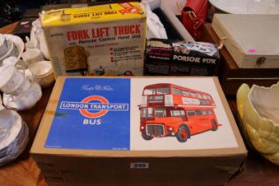 Boxed Tudor Rose London Transport Bus, Boxed Fork lift Truck by Palitoy and a boxed Motora-Wave