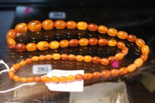 Antique Graduated Amber oval Bed Necklace. 68cm in Length