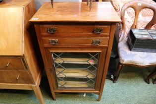 Edwardian Cabinet of 2 drawers with brass drop handles over leaded glazed door and tapering legs