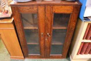 Oak glazed bookcase with key