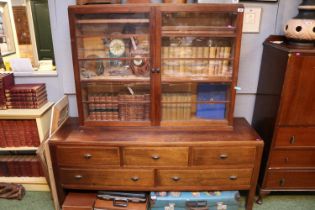 Oak Glazed bookcase over 5 drawer base on straight supports