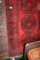 Red Ground Afghan rug with repeated Medallions 180cm in Length and a smaller rug