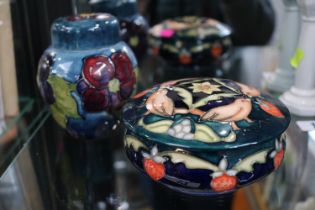 Moorcroft Lidded squat pot decorated with Strawberries and Birds and a Clematis decorated lidded