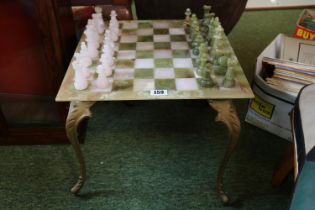 Onyx Chess Table with pieces supported on brass cabriole legs