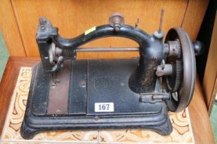 19thC Cast Iron arched back Sewing machine with gilded detail