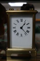 French Brass Carriage clock with panelled glass and Roman numeral dial