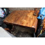 19thC Mahogany drop leaf table of 2 drawers with brass handles with turned central support on played