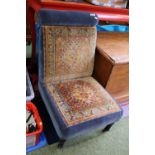 Victorian upholstered low chair with Turned ebonised legs and casters