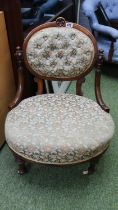 Victorian Upholstered button back low chair on fluted legs and ceramics casters