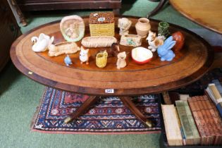 Reproduction Leather topped Oval Coffee table on played legs with brass casters