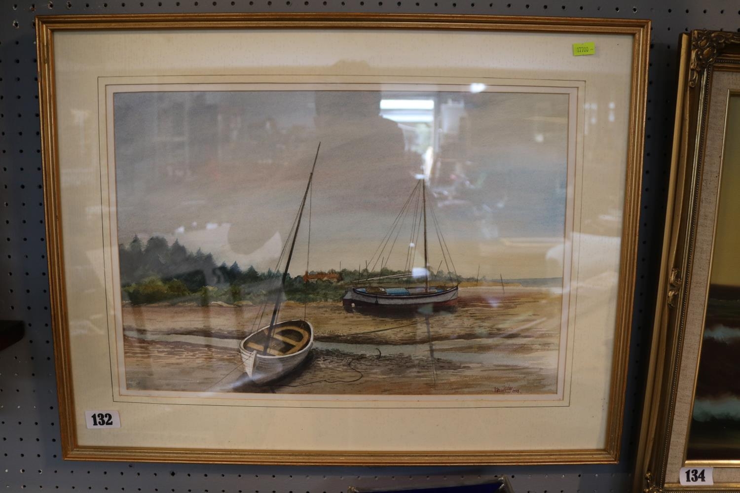 Framed watercolour of fishing boats at low tide signed to bottom right