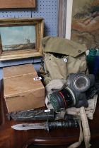 4 WWII Gas Masks relating to a singular family and a Survival Kit Knife in scabbard