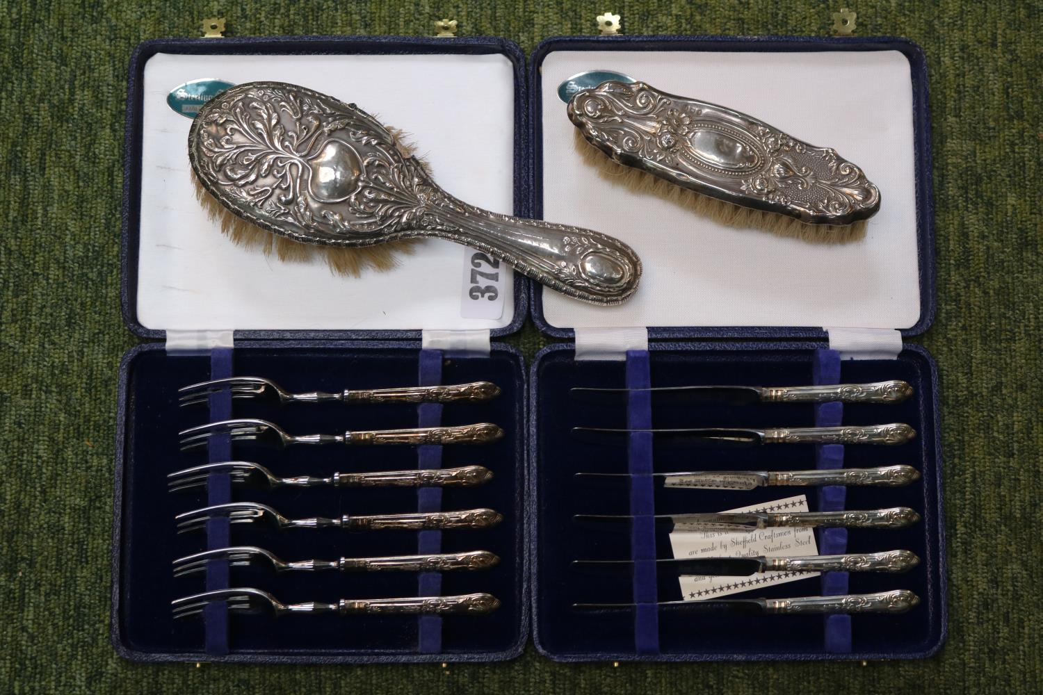 2 Cased Silver handles sets of Cutlery and a Silver backed dressing table brush set