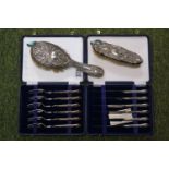 2 Cased Silver handles sets of Cutlery and a Silver backed dressing table brush set