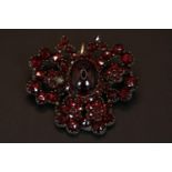 Interesting Cabochon and facetted Garnet Silver set brooch with pin back 13.5g total weight 42mm