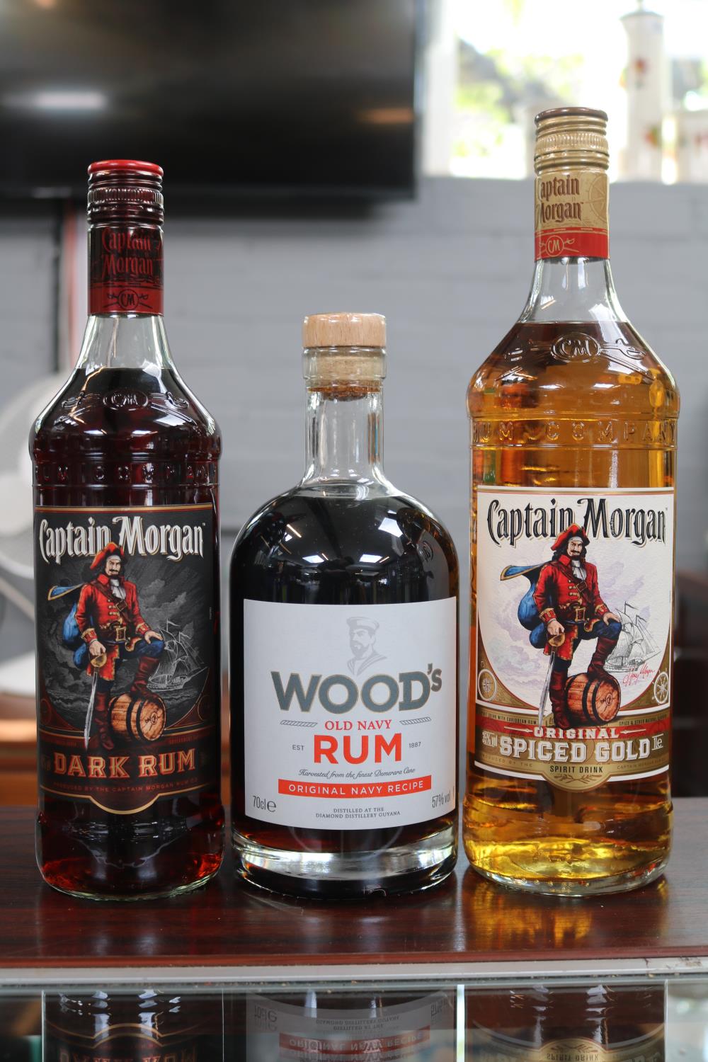 2 Bottles of Captain Morgan's Rum and a 70cl Bottle of Woods Old Navy Rum