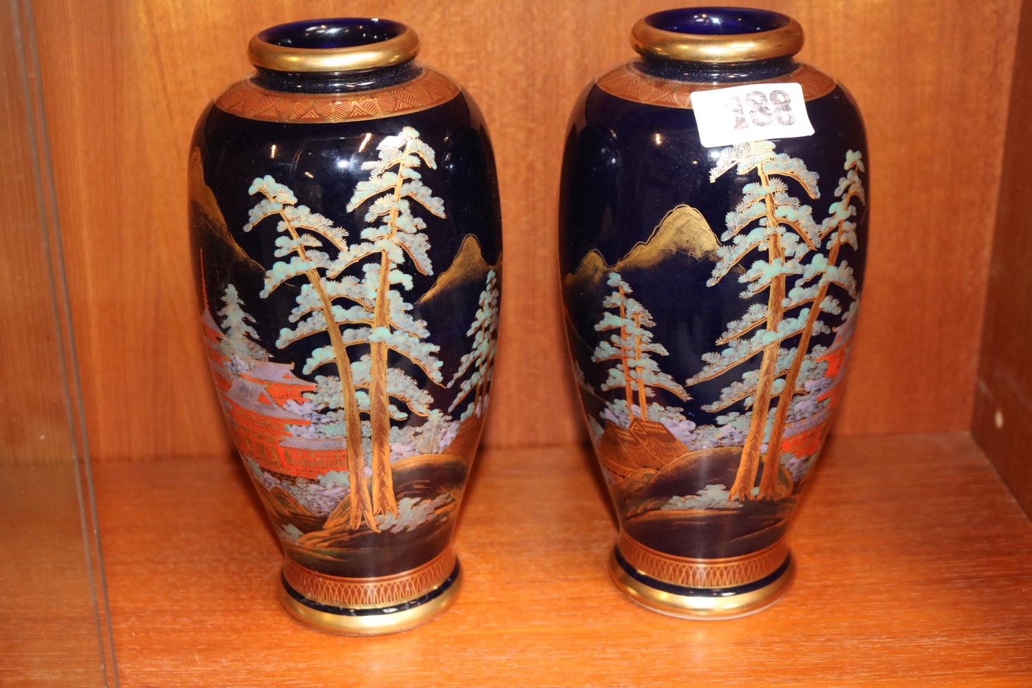 Pair of good Quality Japanese Satsuma Vases decorated with Pagoda and Fir trees, red character
