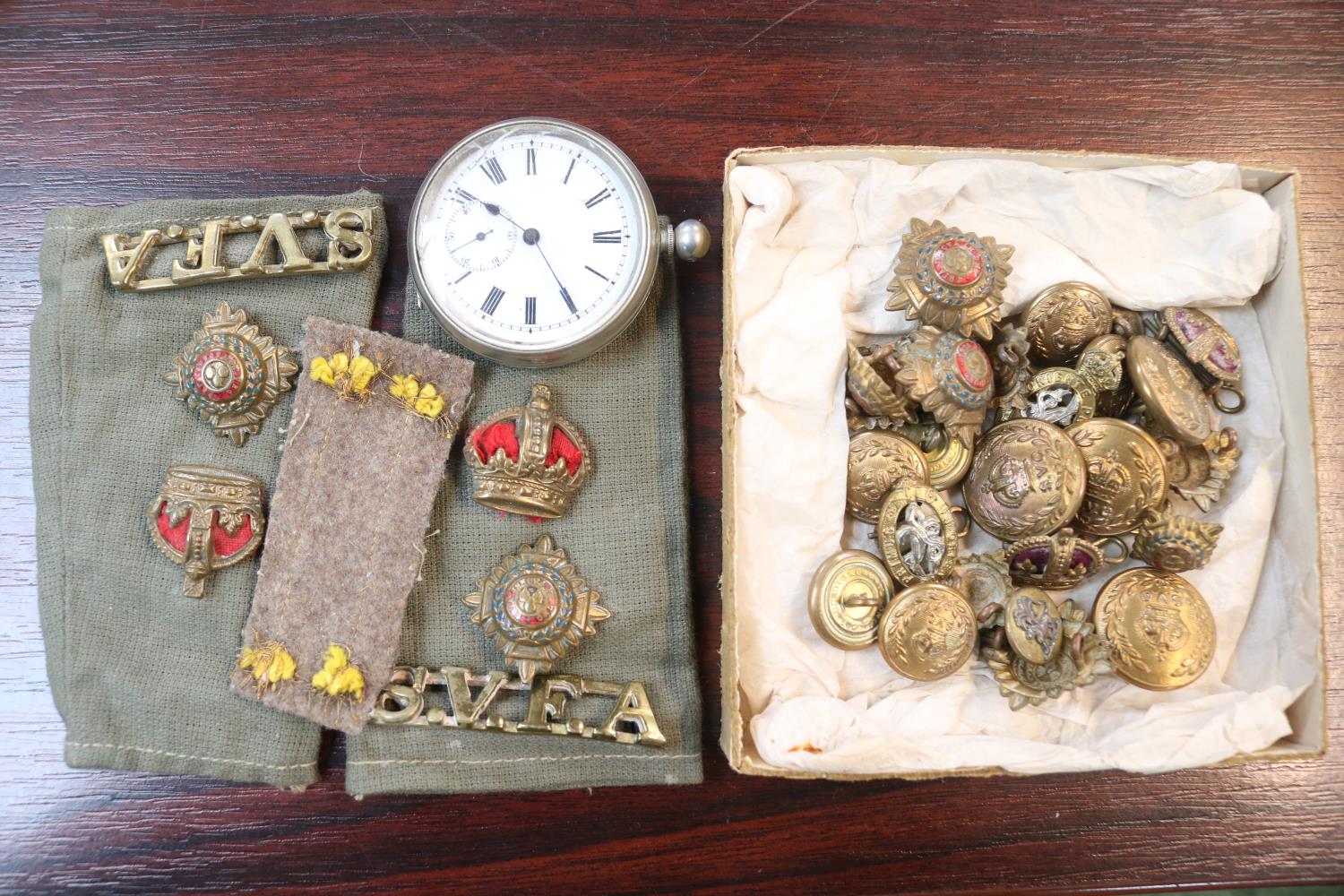 Collection of assorted Military Badges and buttons and a Silver pocket watch with roman numeral dial