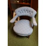 19thC Upholstered Low Elbow chair with button-back upholstery over Fluted legs and ceramic casters