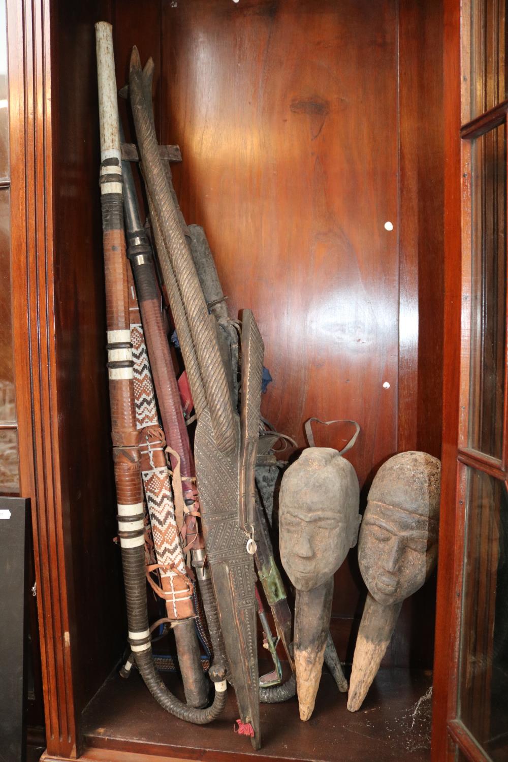 Collection of assorted African Ethnographic Swords, Rifle and a Pair of Hardwood carved heads