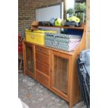 Pine kitchen unit with glazed roors and drawers to centre