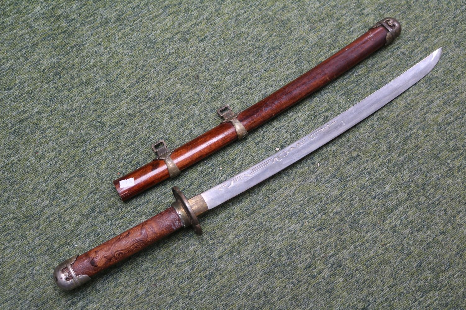20thC Showcase Katana in wooden scabbard with carved handle. 71cm in Length