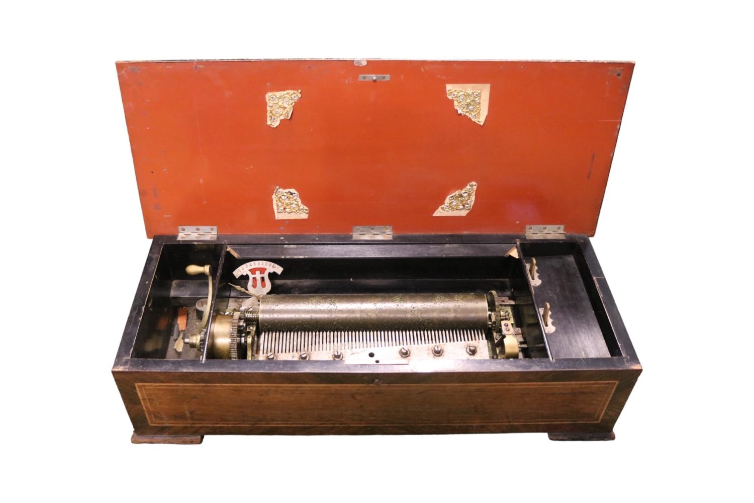 19thC Inlaid Swiss Cylinder Music box of six Airs in need of restoration. 59cm in Length