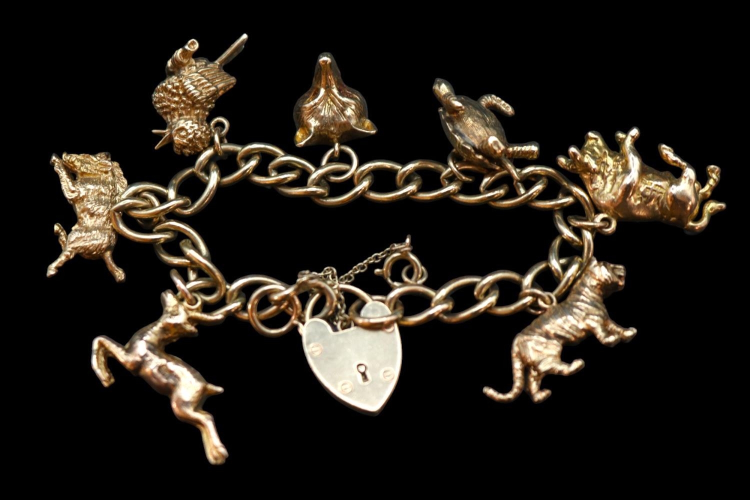 Early 20thC 9ct Gold Charm bracelet comprising of Seven charms to include Tiger, Bull, Turtle,