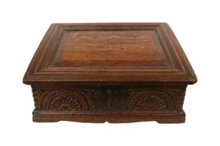 A Georgian oak bible box, early 18th century, the sloped hinged lid above floral guilloche carved