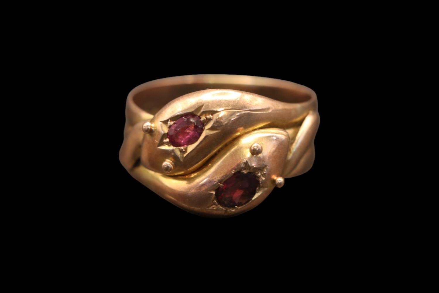 A Victorian double serpent head 9ct gold and Ruby ring. Set with two Oval facetted Rubies