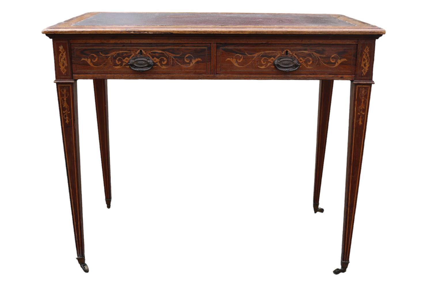 Edwardian Rosewood veneered two drawer desk on tapering legs and brass caster feet. 89cm in Width