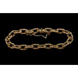 9ct Gold Fancy Link Ladies Chain bracelet of intertwined design with safety chain and push clasp.