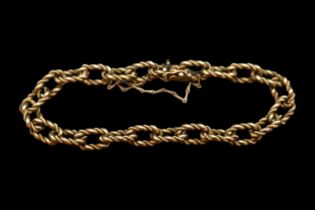 9ct Gold Fancy Link Ladies Chain bracelet of intertwined design with safety chain and push clasp.