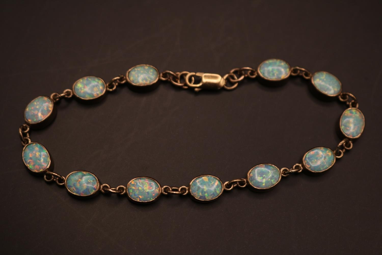 Ladies 9ct Gold Oval Opal set Bracelet. Twelve 9mm Oval Rub over set Opals with Lobster clasp. - Image 2 of 2