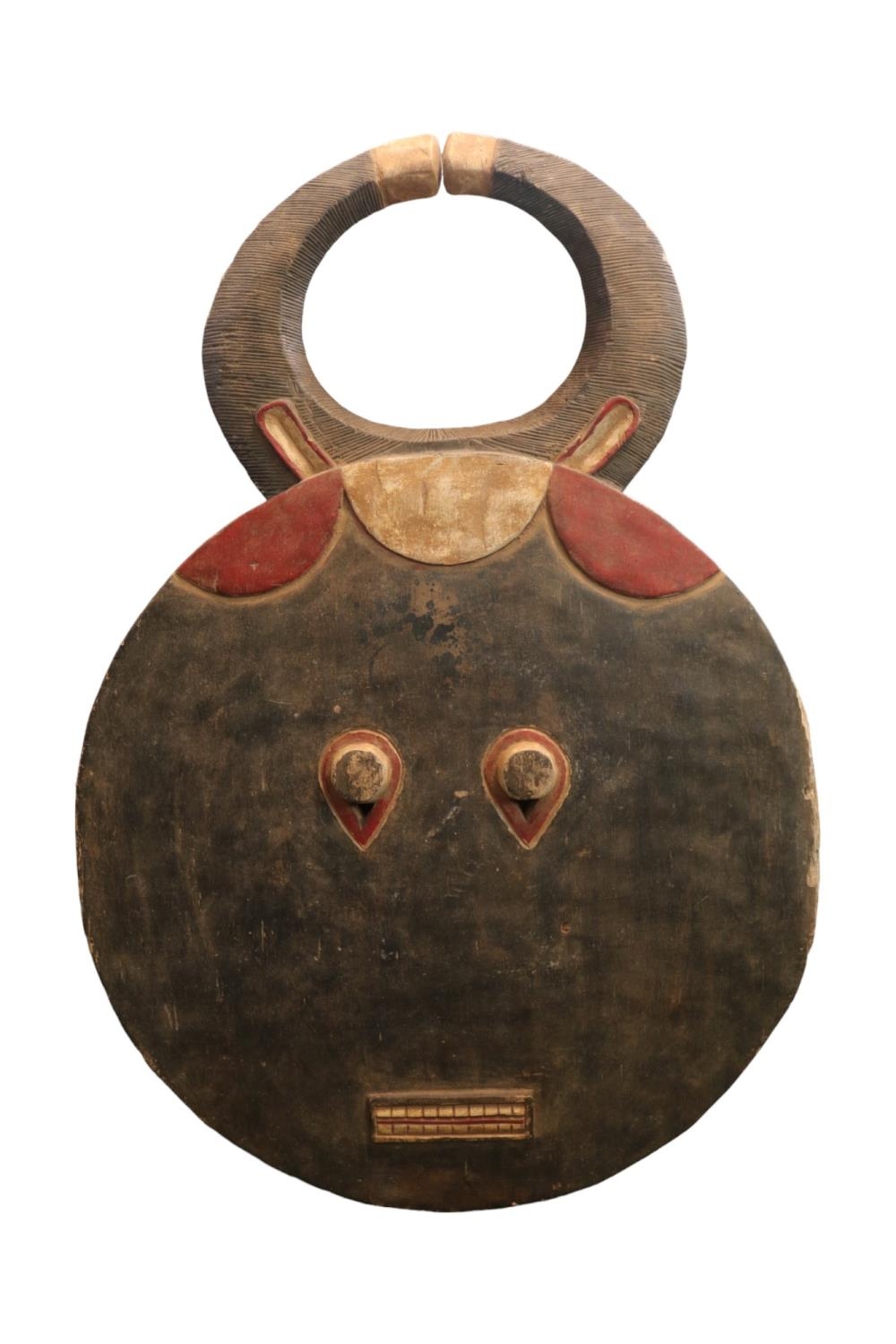Ivory Coast Baule Goli Mask of circular design with rectangular diminutive mouth and large horns.