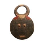 Ivory Coast Baule Goli Mask of circular design with rectangular diminutive mouth and large horns.
