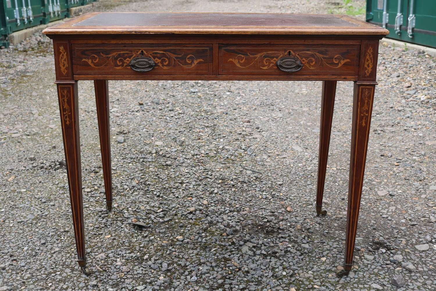 Edwardian Rosewood veneered two drawer desk on tapering legs and brass caster feet. 89cm in Width - Image 2 of 3