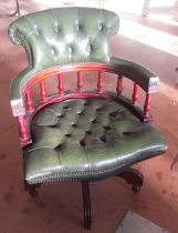 A green leather desk chair