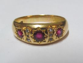 An 18ct three stone ruby and diamond ring, size R 6.3g