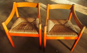 Two Vico Magistretti rush seated chairs (1 rush slightly damaged and both faded)