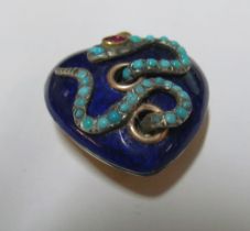 A yellow metal blue enamel heart pendant with snake