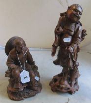 A Chinese carved wood standing Buddha and a seated carved figure