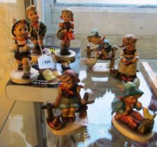 Seven Hummel figures and a book