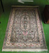 A cream and pink ground floral rug