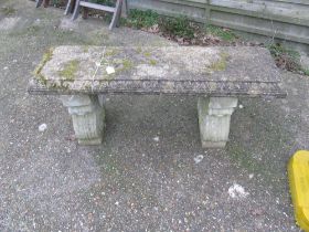 A concrete bench on twin supports