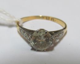 A solitaire diamond ring with illusion shoulders on gold and platinum band, approximately one