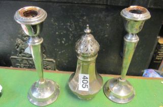 A silver sugar sifter and a pair of silver candlesticks (a/f)