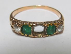 An emerald and diamond ring (one stone deficient)